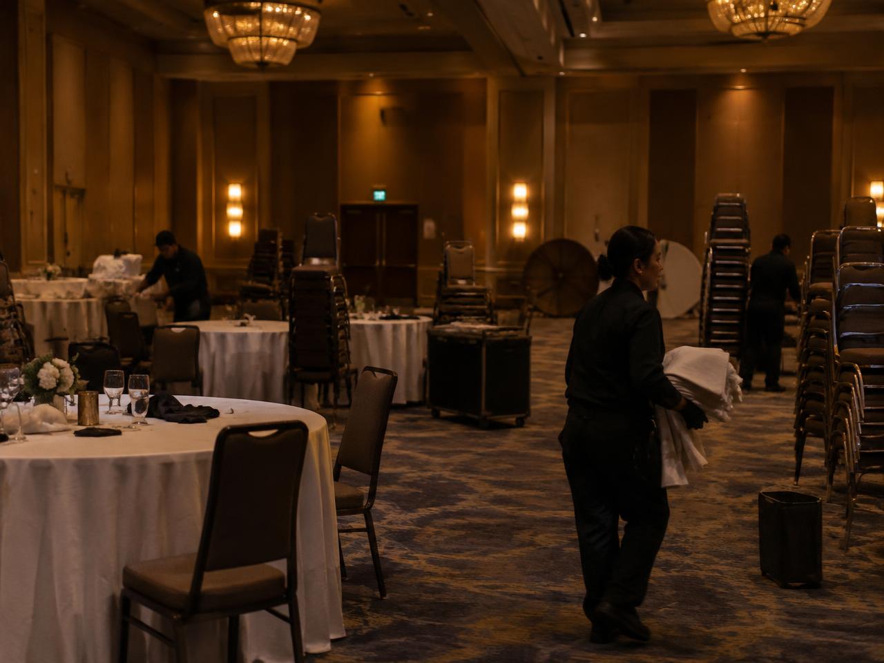Cleaning staff restoring a banquet hall after an event